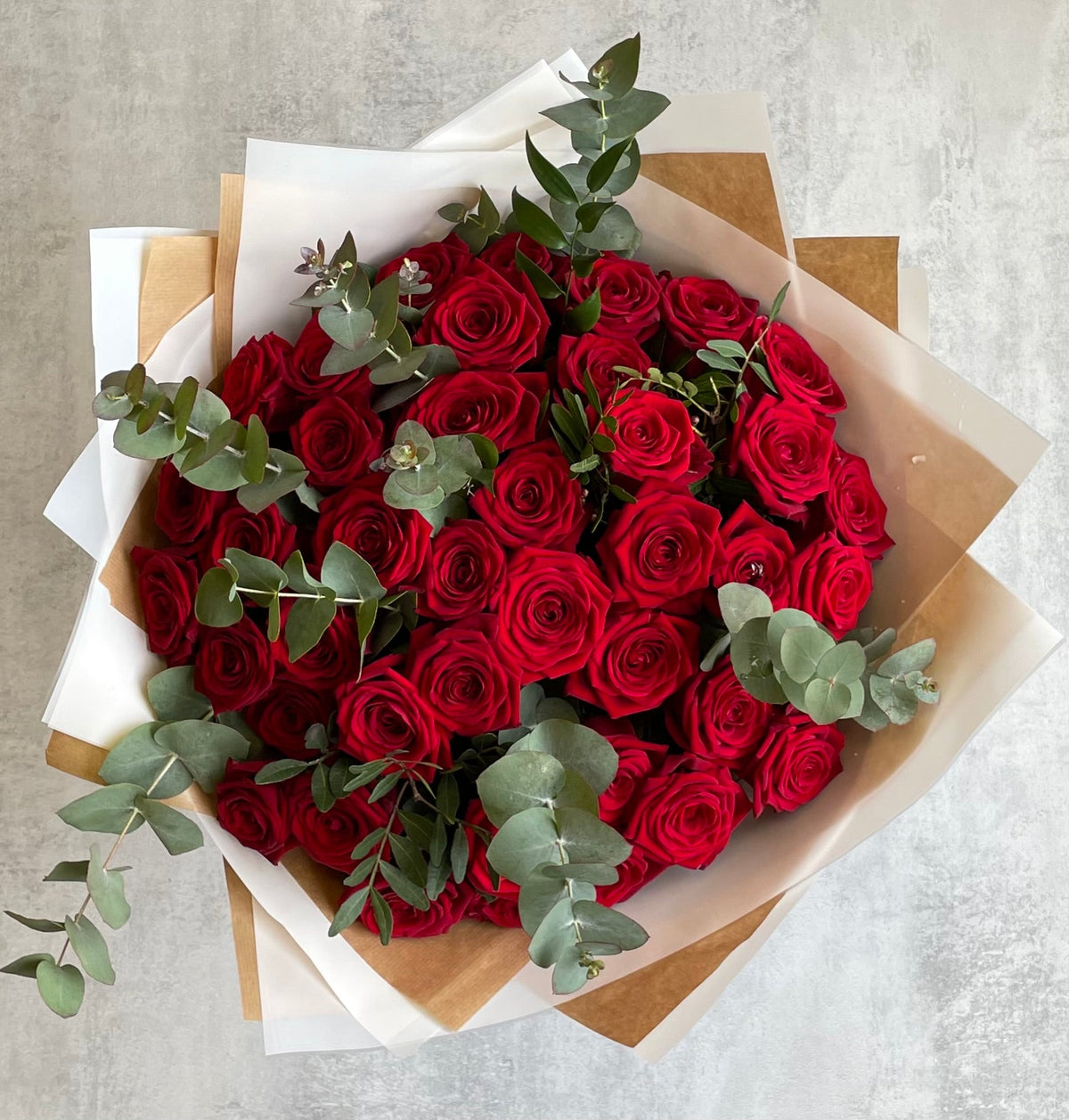 Premium red roses arranged in a hand-tied bouquet